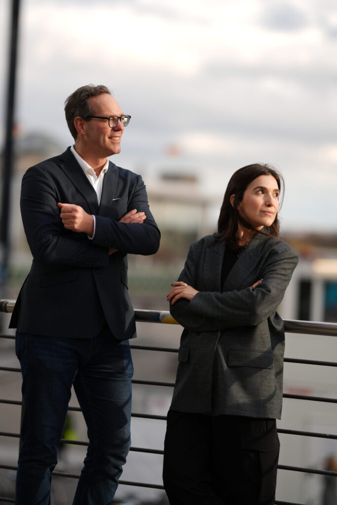 Two business professionals standing confidently outdoors