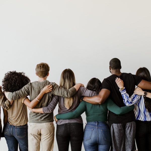 rearview-diverse-people-hugging-each-other